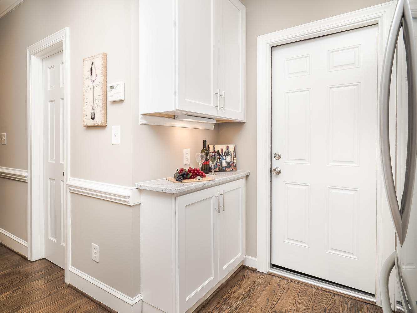 White upper and base cabinets creating a compact serving area