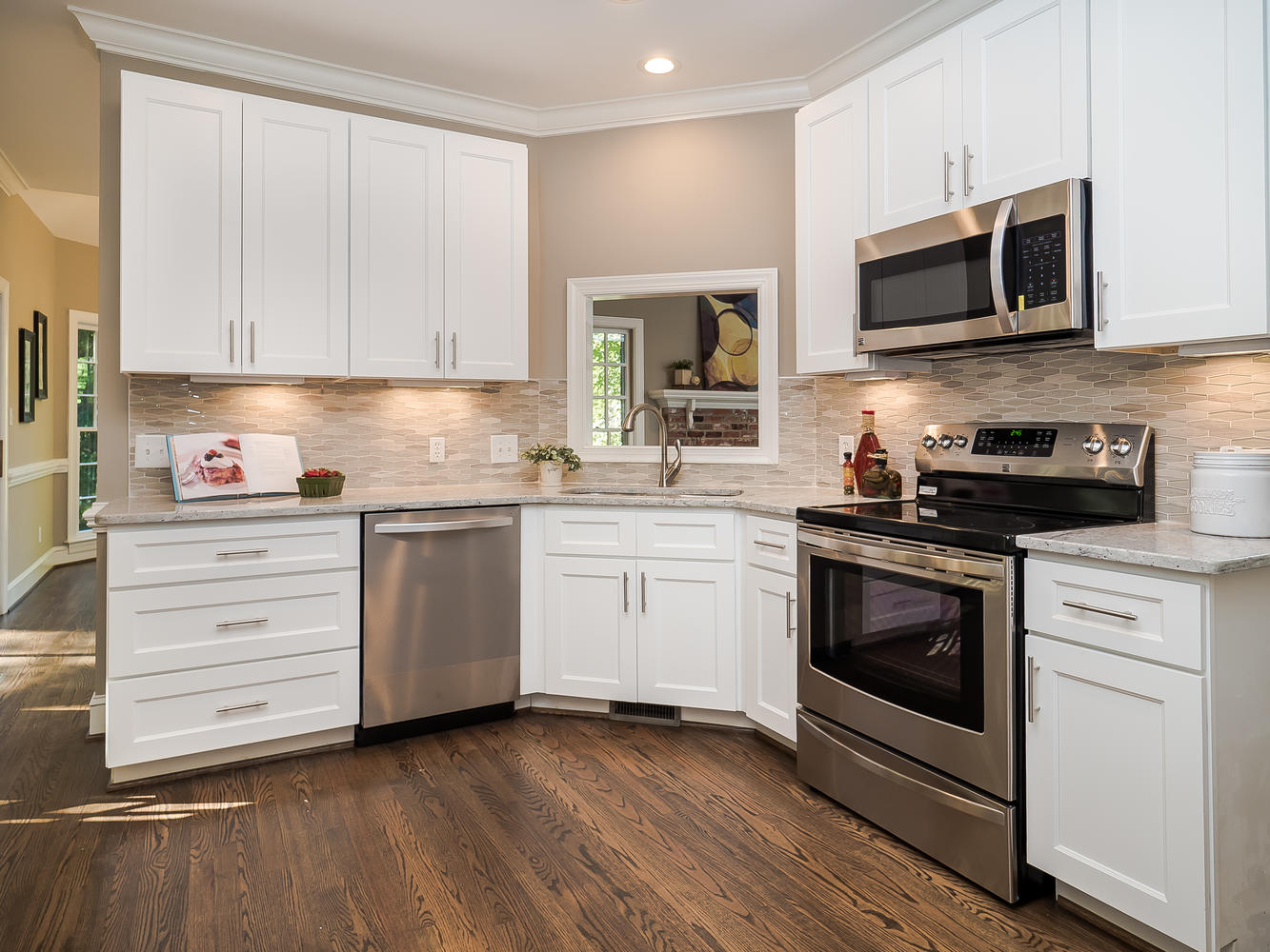 White kitchen cabinetry beneath a 9-foot ceiling with space above the upper cabinets